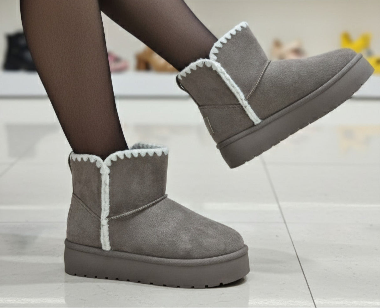 Gray winter boots with white trim worn by a person, with 'TopShike' branding visible.