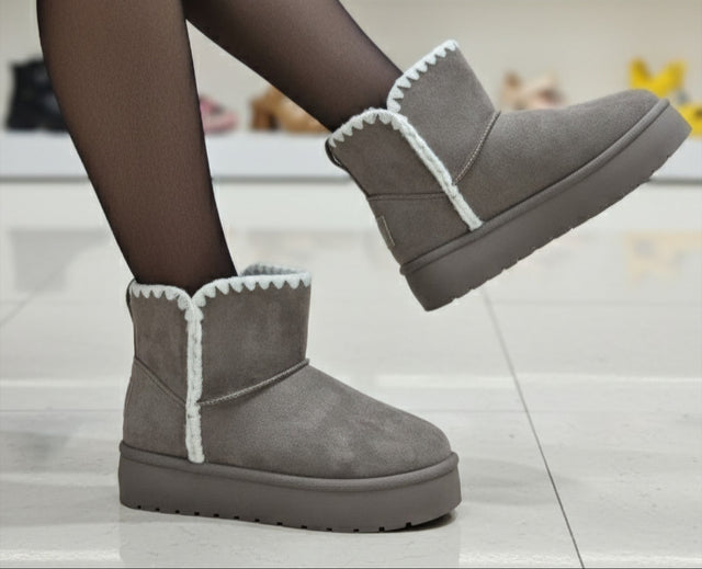 Gray winter boots with white trim worn by a person, with 'TopShike' branding visible.